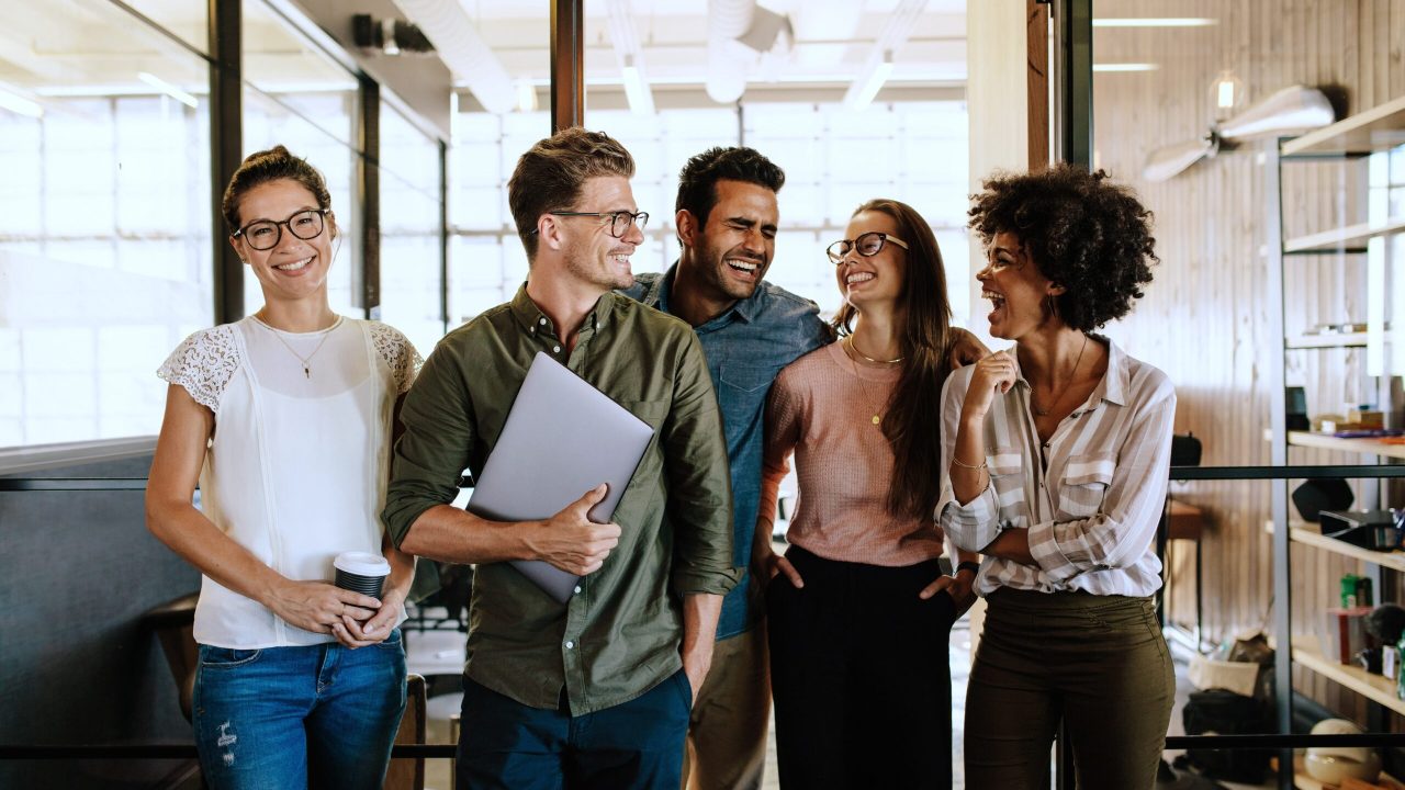 Successful business team standing together and smiling