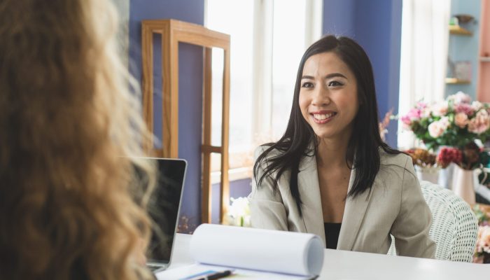 Friendly business woman interviewing new applicant candidate for marketing team staff for her team in the meeting room.