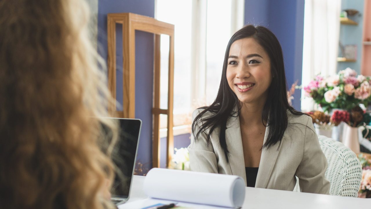 Friendly business woman interviewing new applicant candidate for marketing team staff for her team in the meeting room.